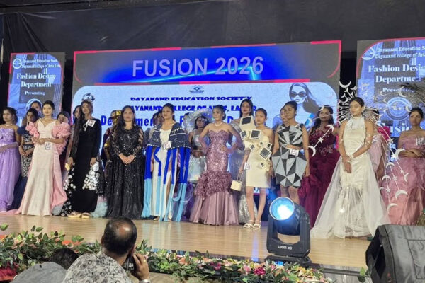 State-level fashion show event at Dayanand Kala Mahavidyalaya Latur with students performing confident ramp walk under bright stage lights.